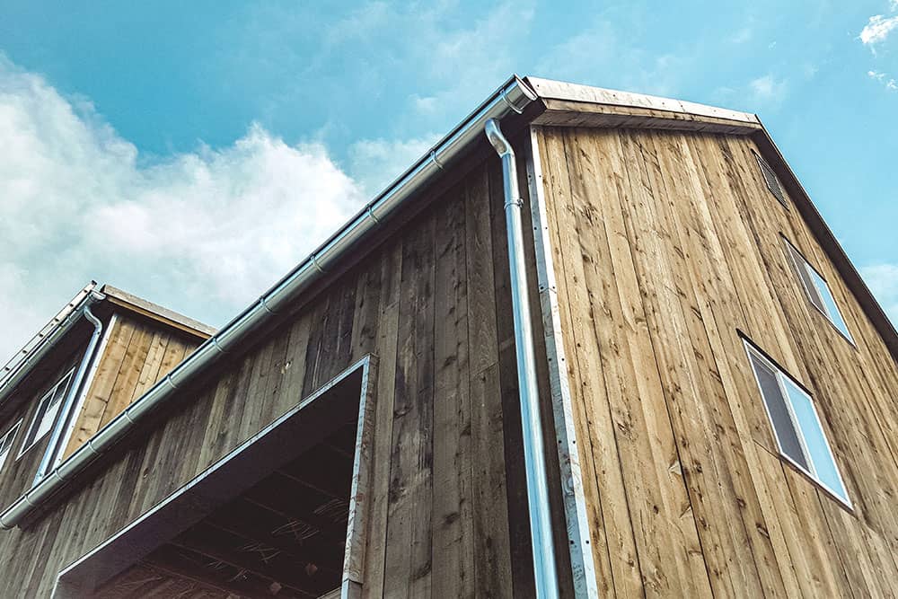 wooden house with newly installed gutters